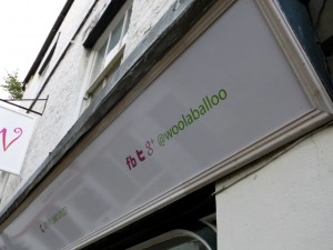 Using a shop sign to promote social media at Hexham's Woolaballoo (10 Sep 2012). Photograph by Graham Soult