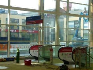 Travelators viewed from Tesco Extra, Gateshead, with Trinity Square and Costa behind (17 May 2013). Photograph by Graham Soult